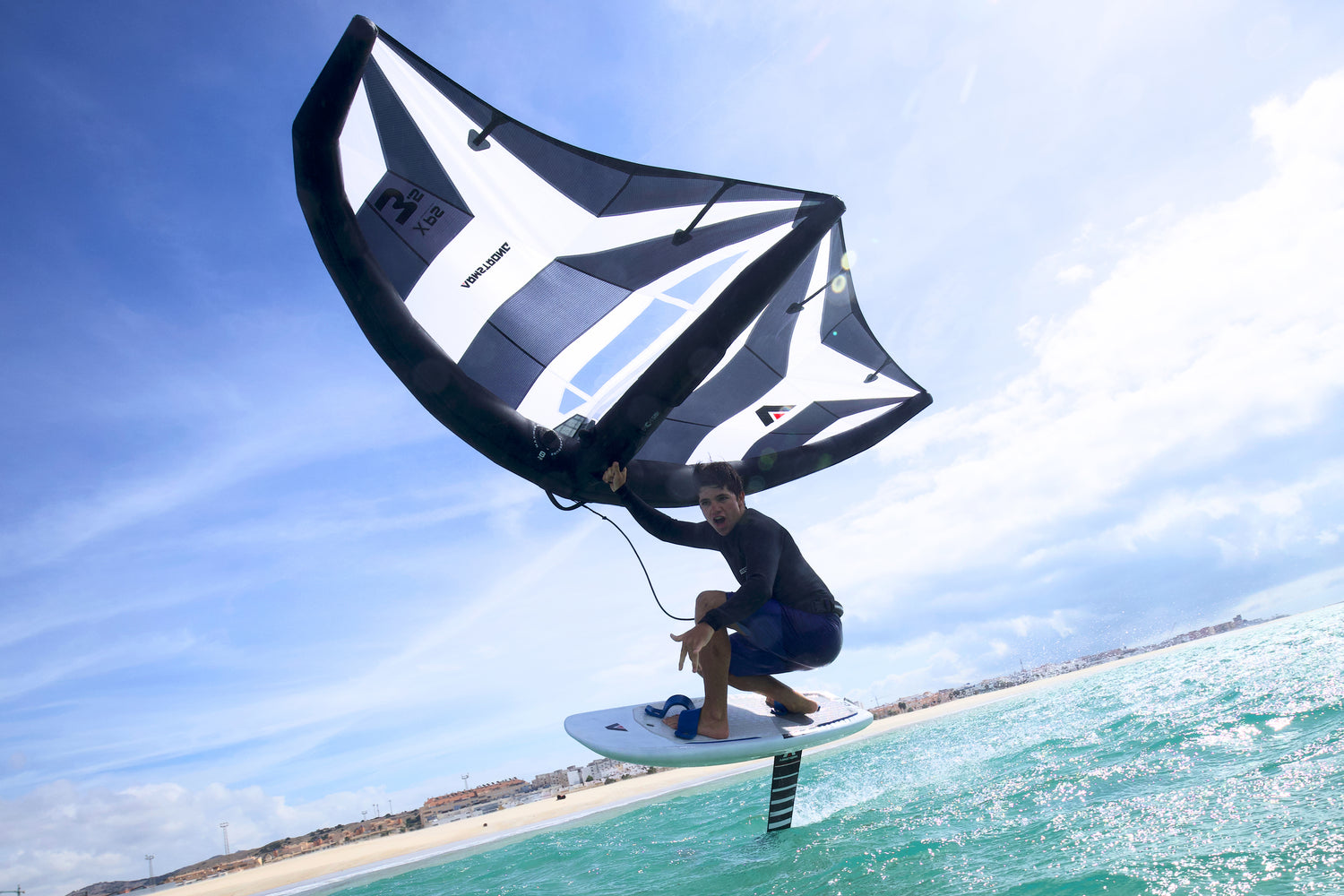 A person wingfoiling and hydrofoiling on an Armstrong XPS Inflatable wing and Midlength Wingfoil board