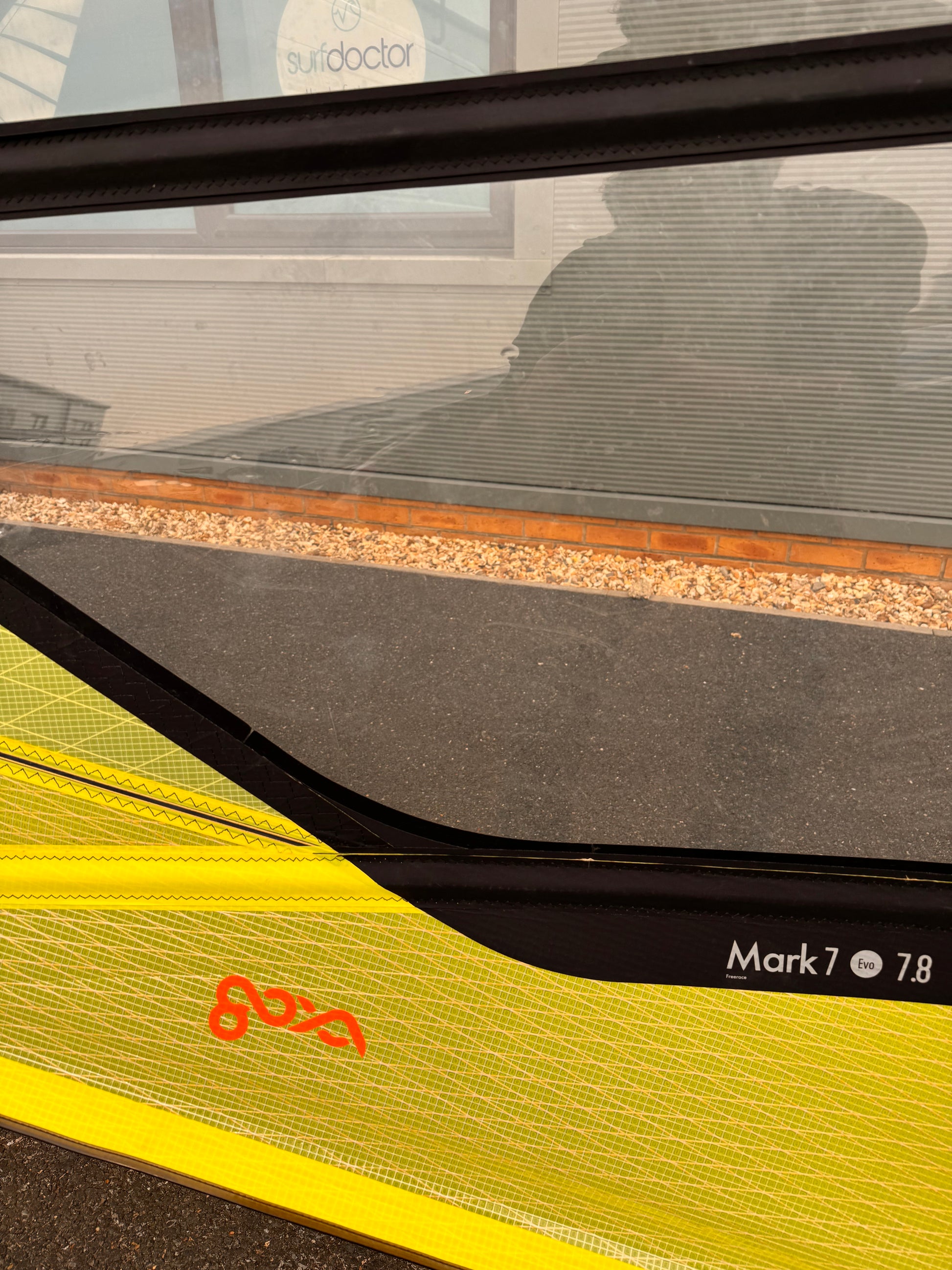 Close-up of a yellow and black windsurf sail with 'Goya' branding.