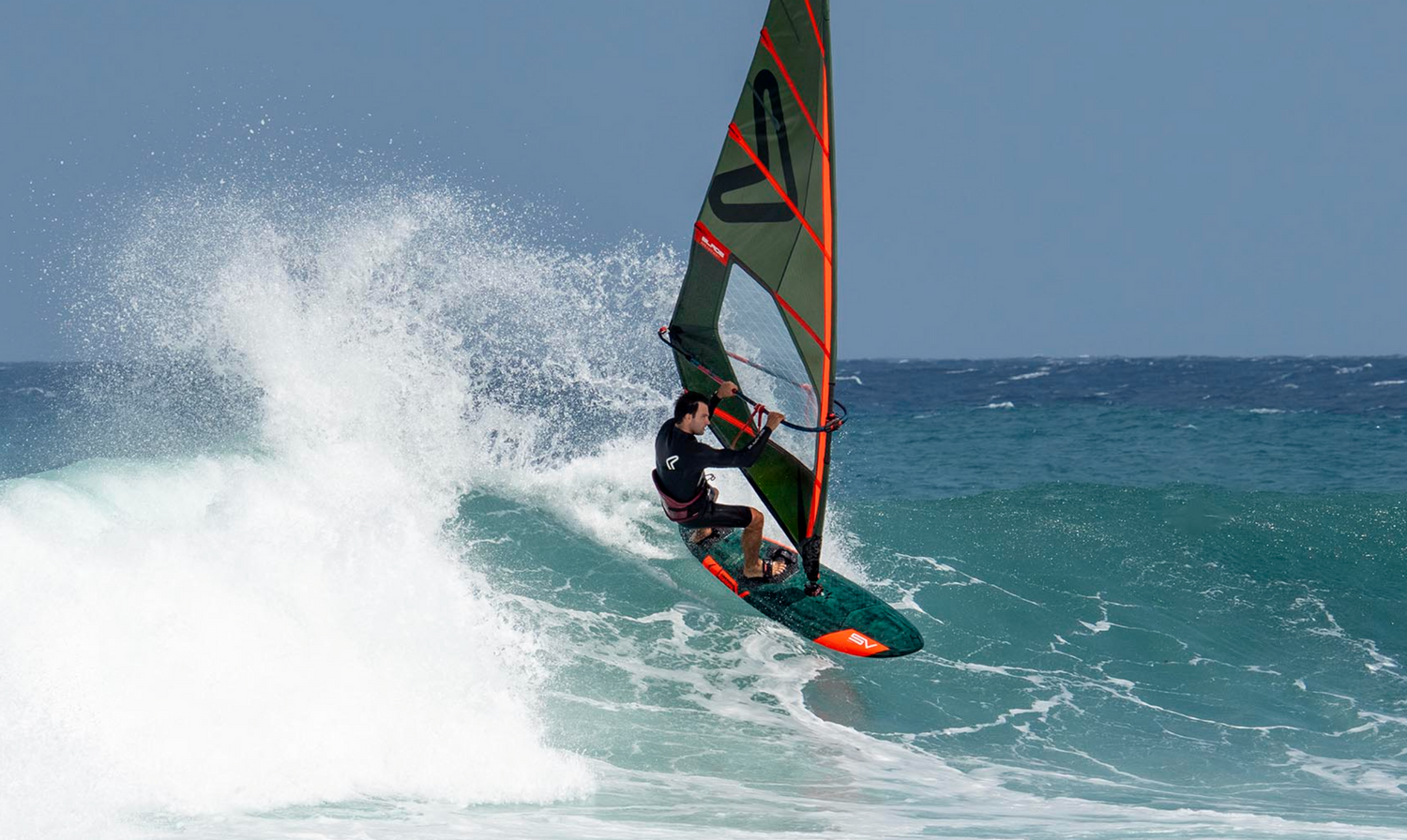 A person windsurfing in waves in a Severne Blade windsurfing Sail 2026