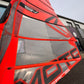 Red and black windsurf sail with Severne Moto in front of Surfdoctor Portland