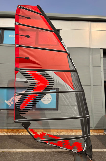 Red and black sail with branding in front of Surfdoctor shop in Portland Weymouth